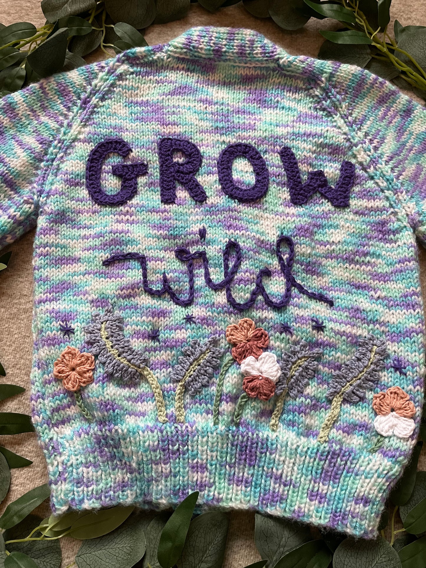 Size 3-5 Years, Grow Wild, Hand knitted Cardigan, Purple/ Blue/ White Fleck, Pocket Flowers