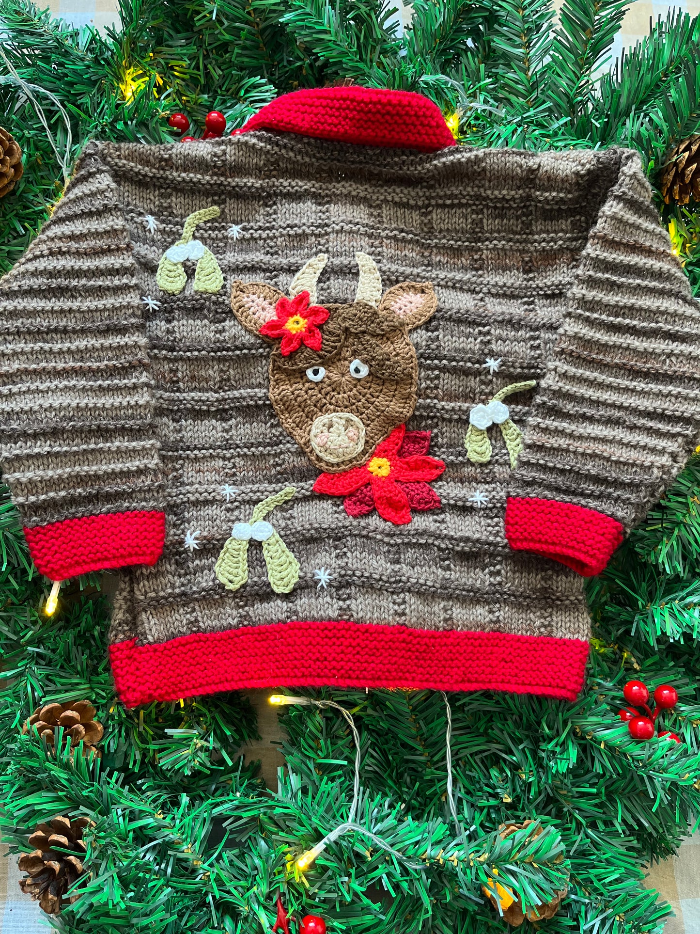 Size 2-3 years, Christmas Cow Cardi, Brown with a red trim.