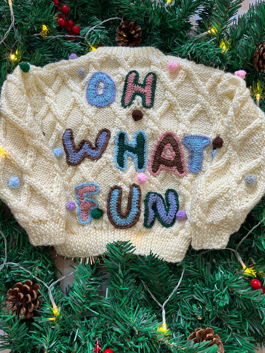 Size 1-2 years, Oh what fun, Cream Hand Knit Jumper with Pom Poms