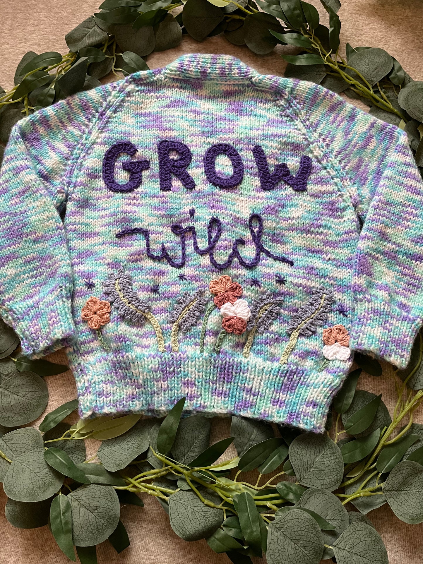 Size 3-5 Years, Grow Wild, Hand knitted Cardigan, Purple/ Blue/ White Fleck, Pocket Flowers